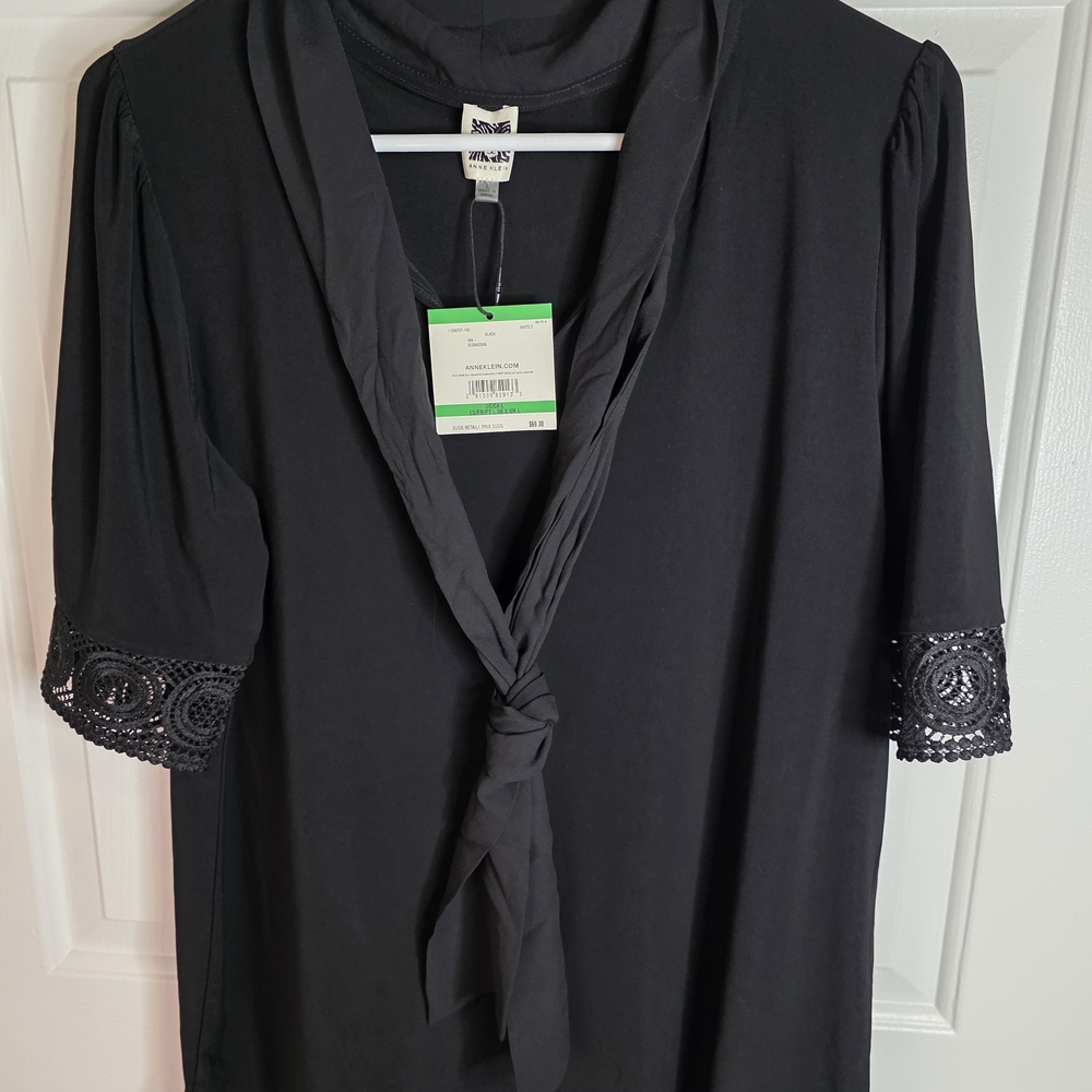 black Anne Klein top with a necktie and lace cuffs